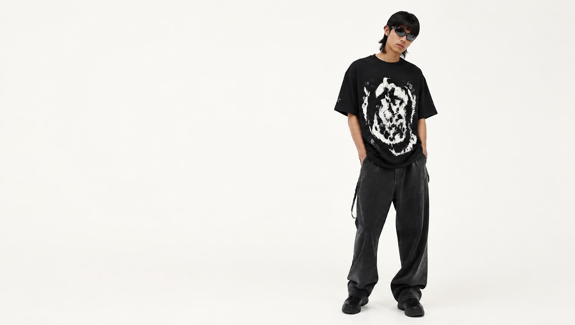 Model wearing a KANVAS black oversized graphic tee